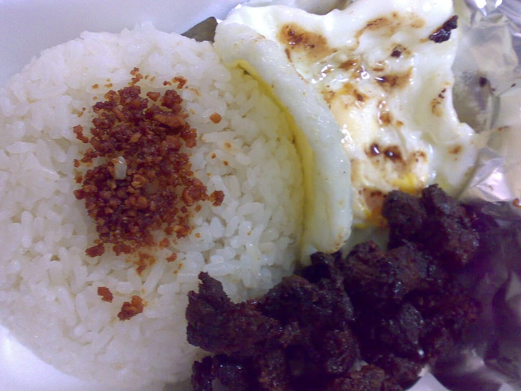 A tapsilog plate: rice, beef tapa and a fried egg